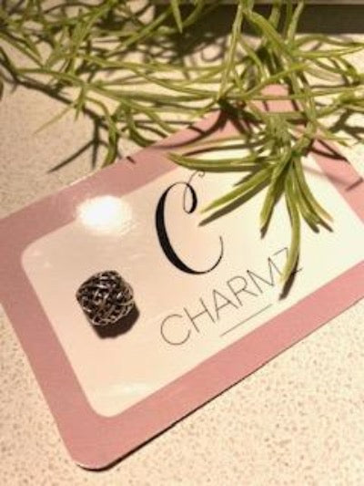 Abstract silver charm